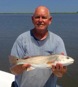 Capt Jack with a nice schoolie redfish.