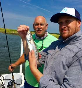 Zach with a seatrout. Capt. Jack is in the background.