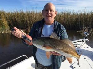 Capt. Jack catching a nice red on a Glup swimming mullet.