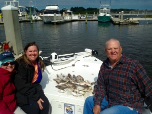 Amy Collins, Tracy McDonald and their father Mike Prior catching a mess of wihiting.