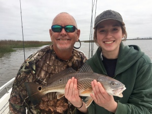 Capt. Jack is next to Susannah Rubin with a redfish she just caught.