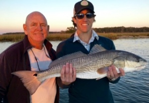 JT landing a nice inshore red! Capt. Jack is to JT's right.