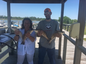 Shirely and Isacc holding some schoolie reds.