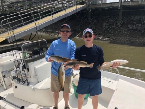 Joel Hemphill & his son Tucker with some nice schoolie reds.