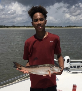 Elijah Brittan with a nice red drum. Elijah & Austin catching some reds & whiting close to beachfront.