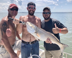 Bob, Isacc & Buddy with a large red. Isacc is in middle with the fish he caught.