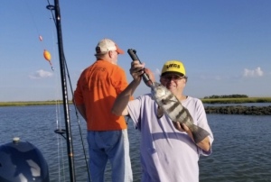 John Gross holding nice black drum. Larry Spears is in the back ground. The guys had a nice catch of reds, sea trout & black drum.