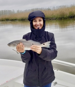 Brandy & Brian Williams catching and releasing some schoolie reds. Brandy is holding a schoolie red.