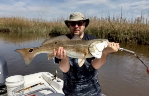 Chad Clawson with a large red drum! Chad caught a variety on a windy day.