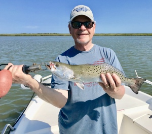 Jack Adams catching & releasing a variety of fish. Jack is holding a nice sea trout.