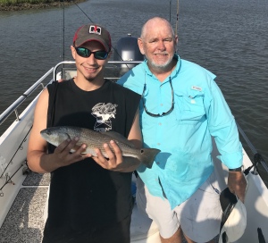 Kai and myself (Capt. Jack). Kai is holding a nice schoolie red. Kai, Ron & Corey worked up some nice ones.