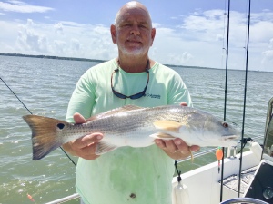 Capt. Jack catching & releasing a nice red. Jack & childhood friend on nice bite.