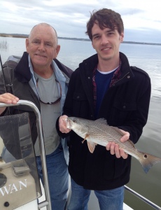 Capt Jack in background John Wilson with an 18 inch redfish caught on a mud minnow under a DOA popping cork. High tides and slow fishing.