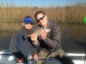 Davis Garrison and his Dad with a schoolie red Davis caught