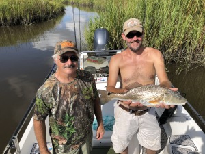 Isacc with a nice red.  His uncle Jimmy is  on his right.