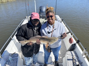 Anjelica Dobson catching & releasing a nice red!