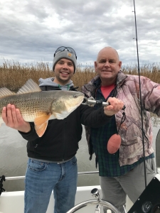 Kyle & Capt. Jack with a large redfish.