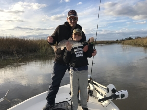 Troy Murphy and Andrew with a nice red on windy high water day. Fishing in a head of a creek.