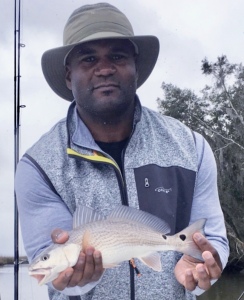 Brian & Brandy Williams catching & releasing some schoolie red. Brain is holding a schoolie red.