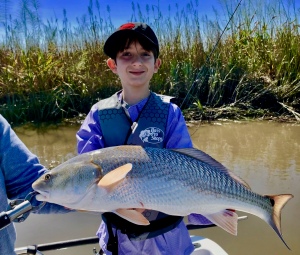 Young fisherman George with a large red!  George caught fish on a big tide!