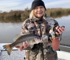 Cathy McGowan with a strange catch of large mouth bass in 48 degree water.
