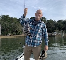 Jack & Cathy catching & releasing some sheepshead.  Jack is holding a  sheepshead.